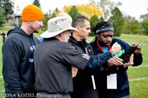 Tony Jones from Lane Tech asked me to help him identify runners  in his Ipad video of the finish, with the meet results still in doubt among the coaches.  Photo by Ilona Koziel.